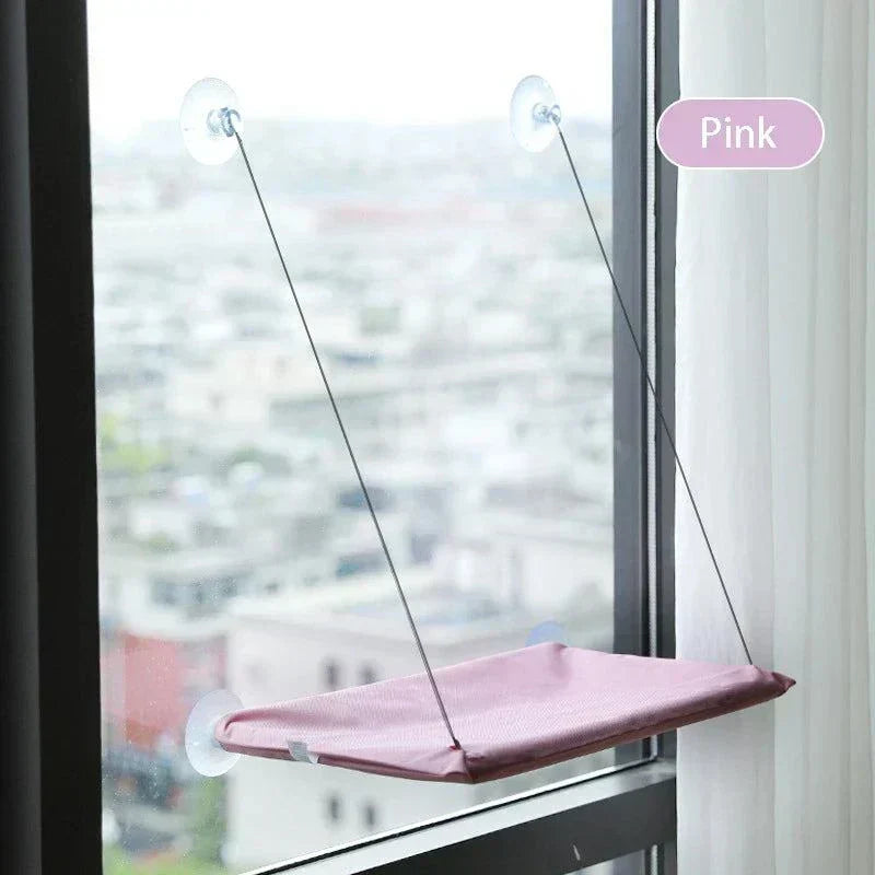 Cat Window Perch in pink with sturdy suction cups and steel frame, providing a sunny spot for cats.