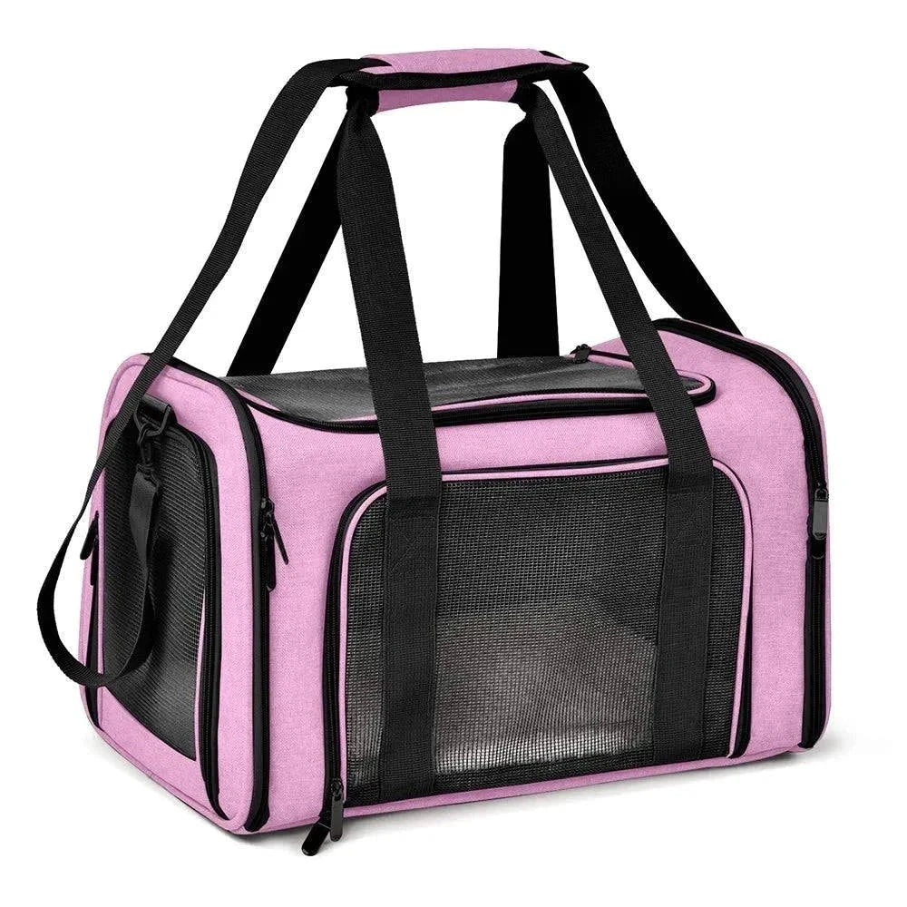 Premium soft-sided pet carrier in pink with mesh panels, adjustable shoulder strap, and padded handles for pet comfort and travel convenience.